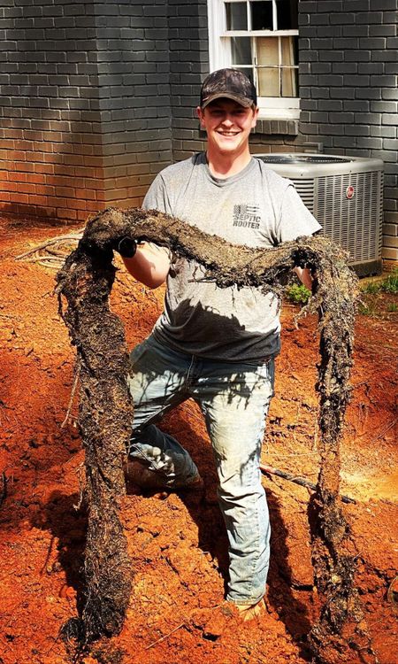 SepticRooter™ technician gets to the ROOT of the problem in Acworth — root-invaded septic pipe