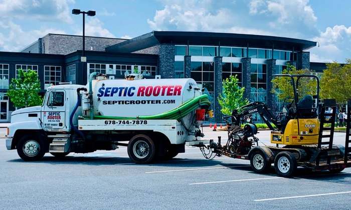 SepticRooter™ service truck and excavator on a septic repair job in Covington, Georgia