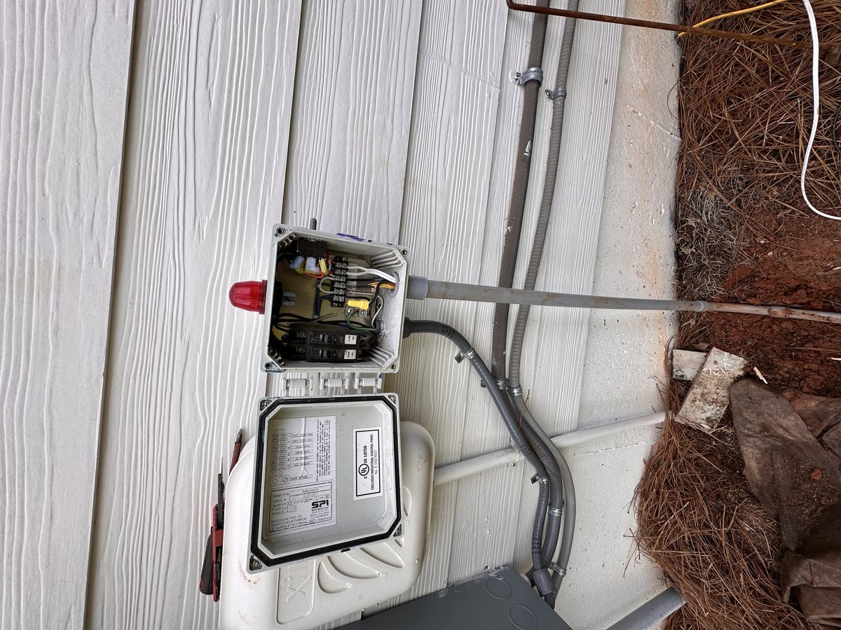 Open septic control panel with red alarm dome and pump and alarm breakers