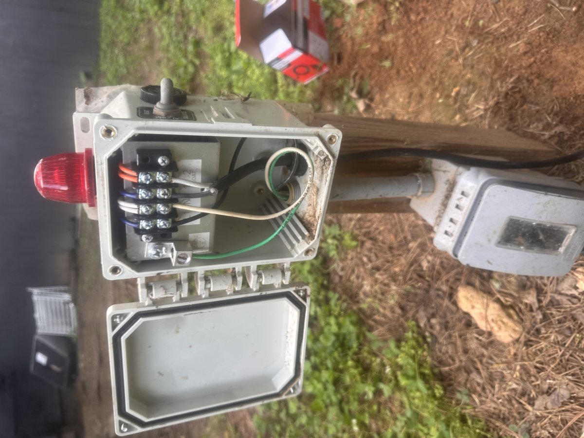 Open pole-mounted septic alarm panel with red light and silence switch